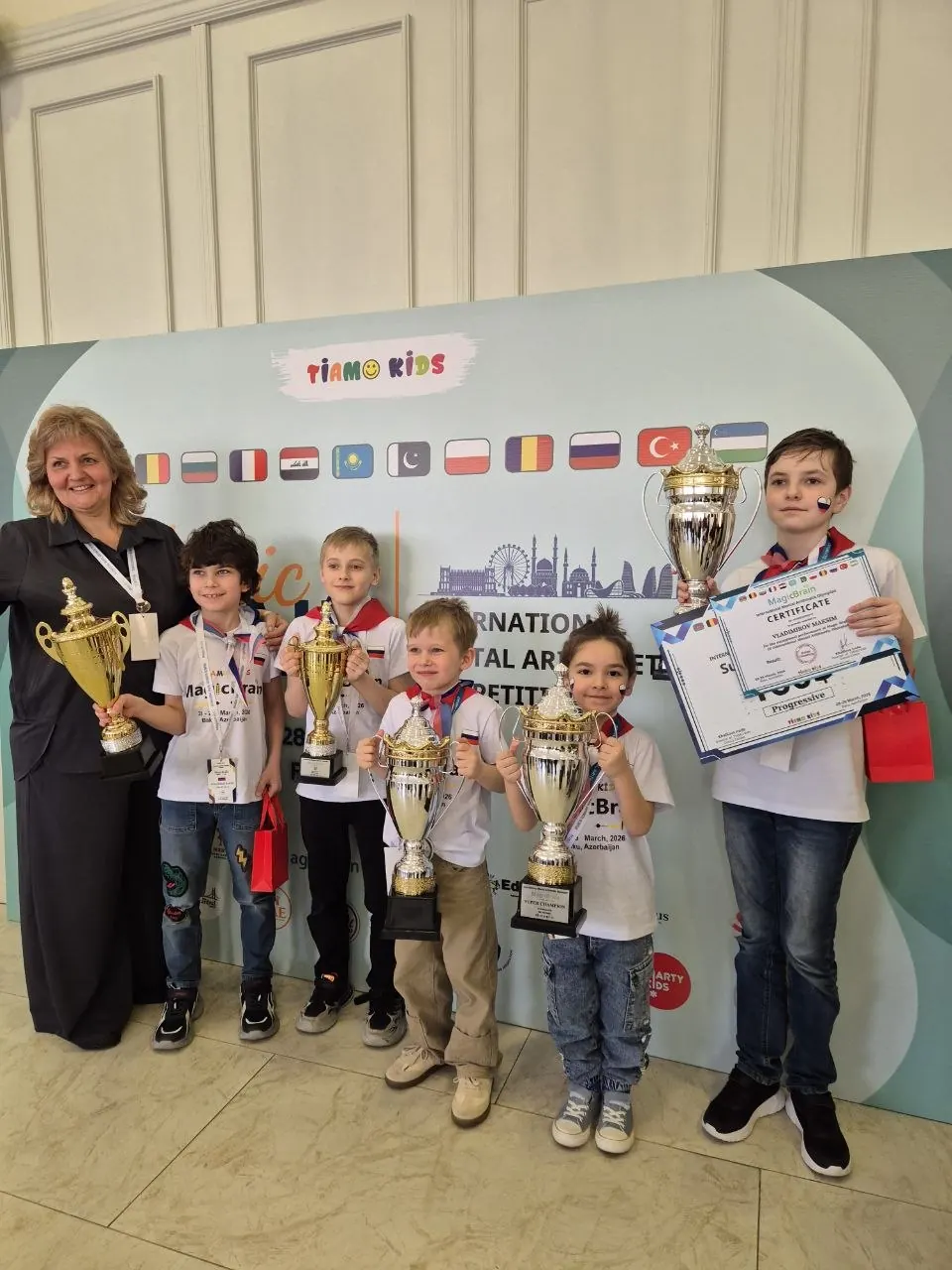 Young Abakus champions holding trophies
