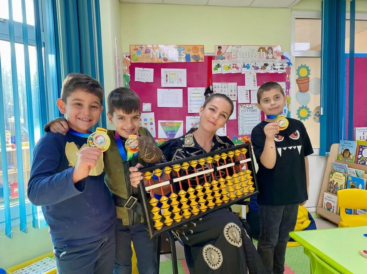 Abakus pupils and their teacher celebrating with medals